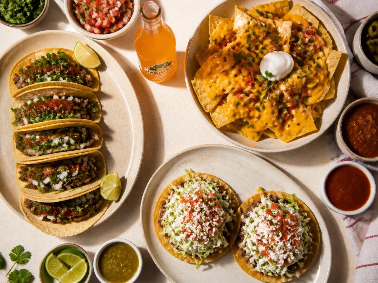 Street tacos, cheesy nachos and tostadas served together